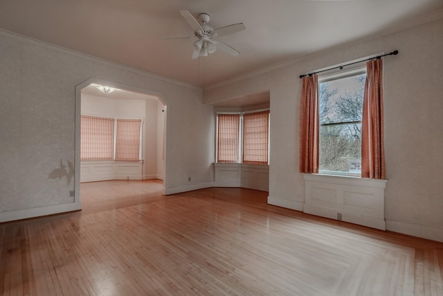 spare room featuring ornamental molding, ceiling fan, and light hardwood / wood-style flooring