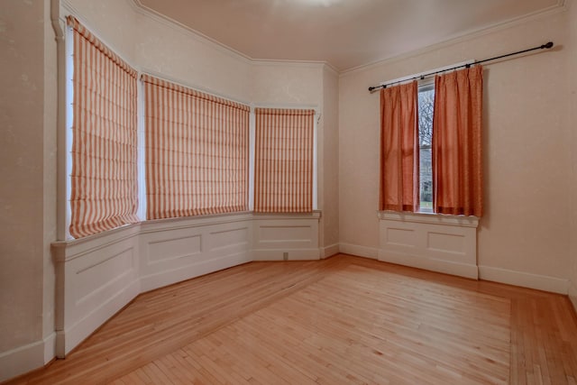 spare room with wood-type flooring and crown molding