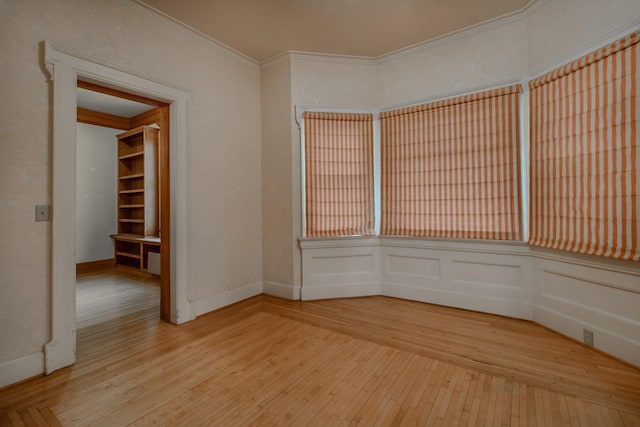 unfurnished room with crown molding and wood-type flooring