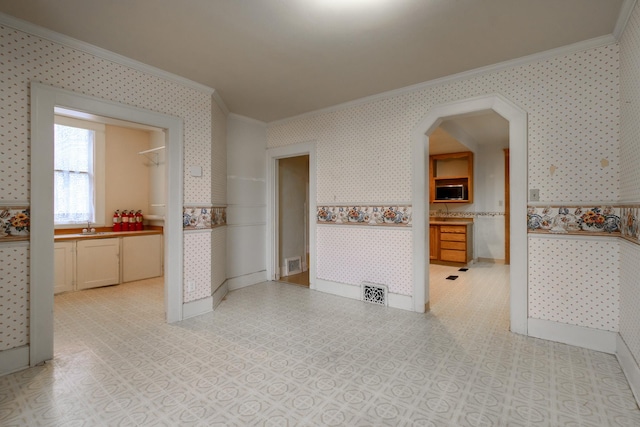 spare room with ornamental molding and sink