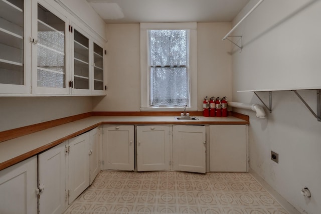 kitchen featuring white cabinetry and sink