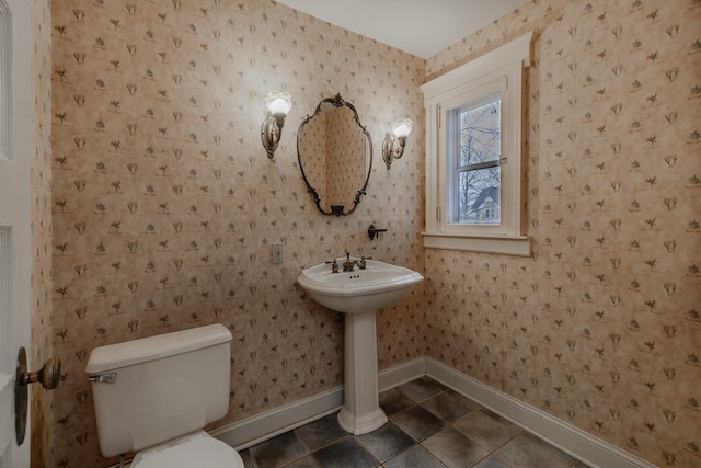 bathroom with tile patterned floors, toilet, and sink