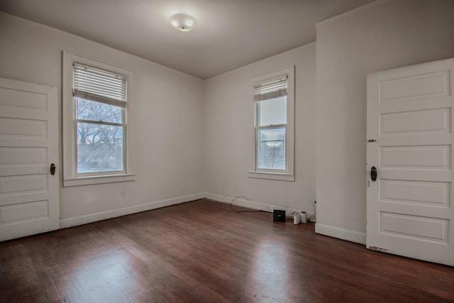 unfurnished room with dark wood-type flooring and a healthy amount of sunlight