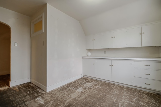 kitchen with white cabinetry and vaulted ceiling