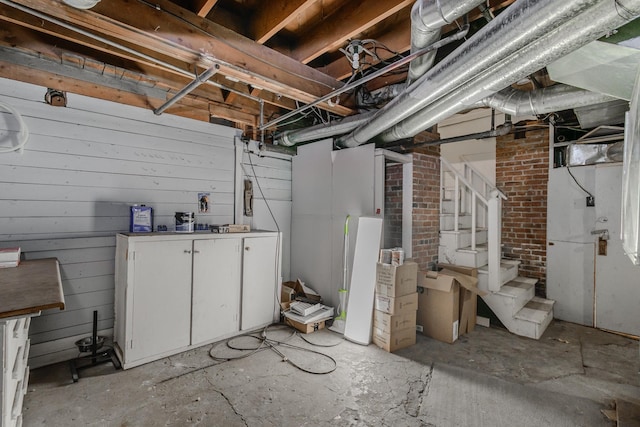 basement featuring wood walls