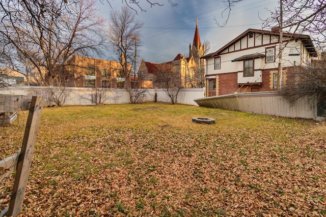 view of yard with a fire pit