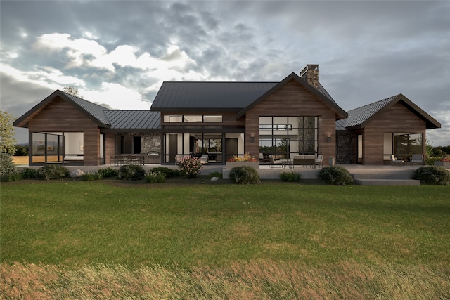 rear view of house with a yard and a patio