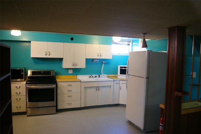 kitchen with white cabinetry, appliances with stainless steel finishes, and sink