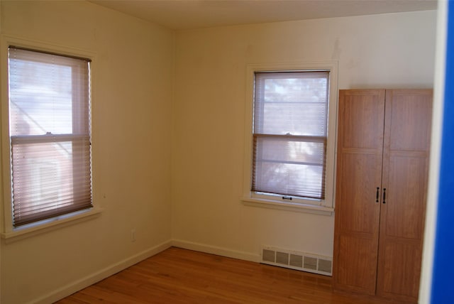 spare room with wood-type flooring