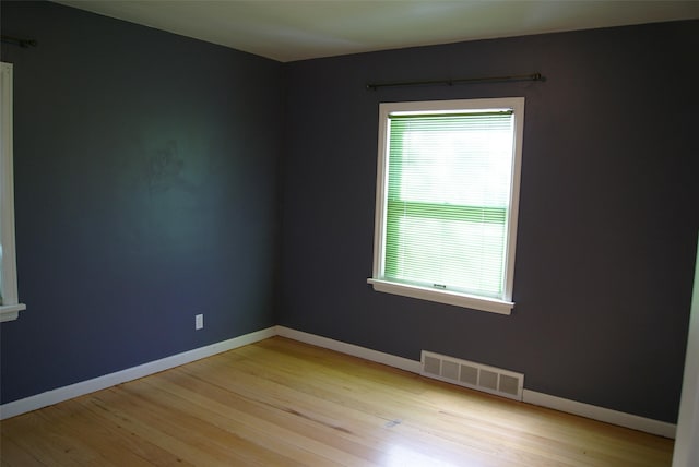 unfurnished room with light hardwood / wood-style flooring