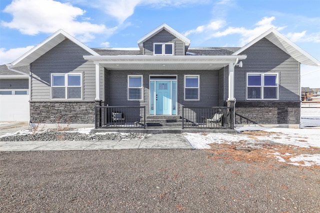 view of front of house featuring a garage and a porch