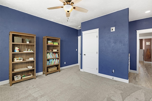 bedroom featuring carpet, a textured ceiling, and ceiling fan