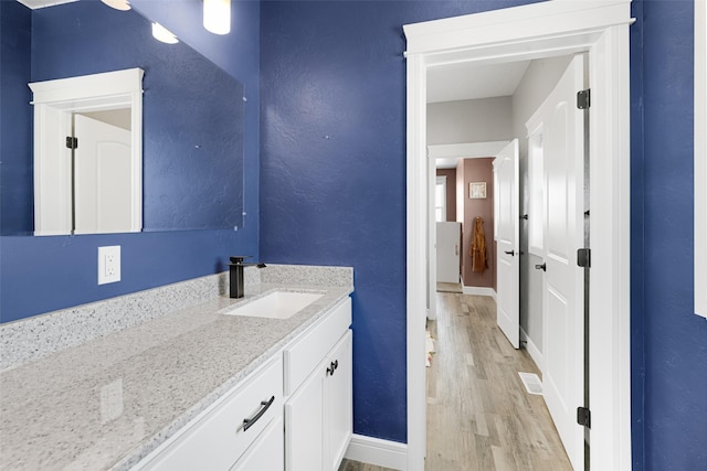 bathroom with vanity and wood-type flooring