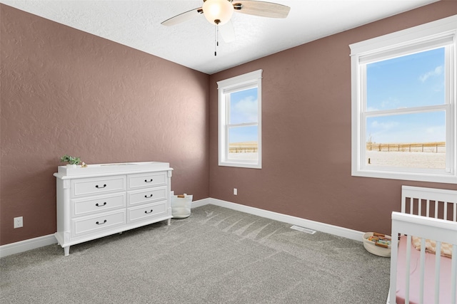 unfurnished bedroom featuring light colored carpet and ceiling fan