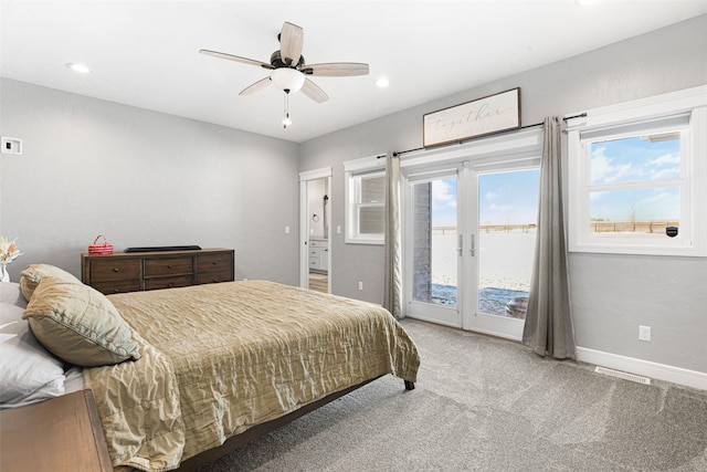 bedroom featuring french doors, a water view, ceiling fan, access to exterior, and carpet