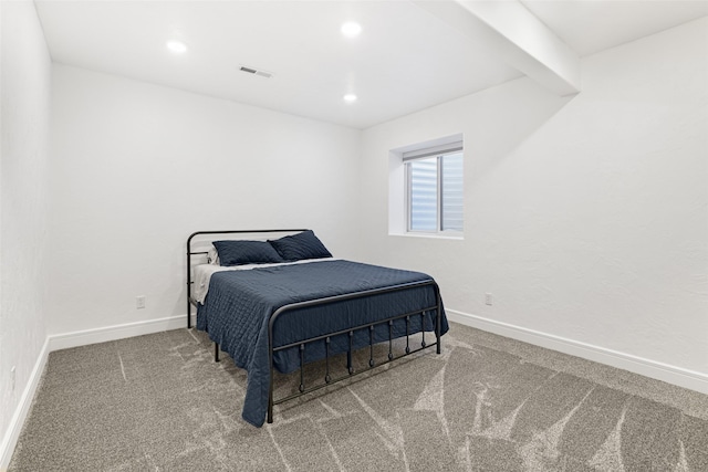 carpeted bedroom featuring beamed ceiling