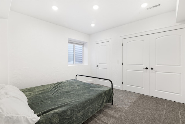 bedroom featuring two closets and dark carpet