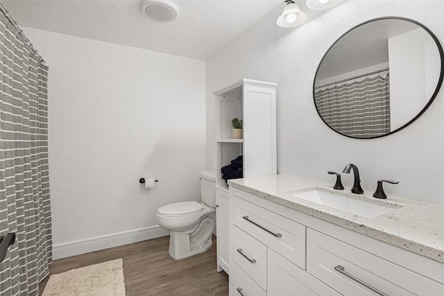 bathroom featuring vanity, hardwood / wood-style floors, and toilet