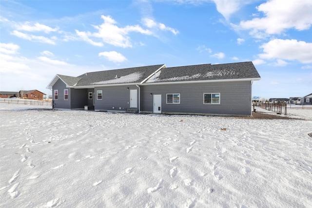 view of snow covered rear of property