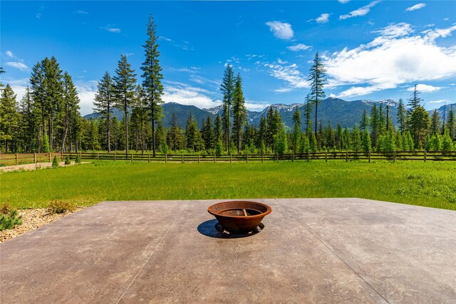 3900 Foothill Rd, Kalispell, MT 59901 - view of patio featuring a fire pit, a mountain view, and a view of countryside