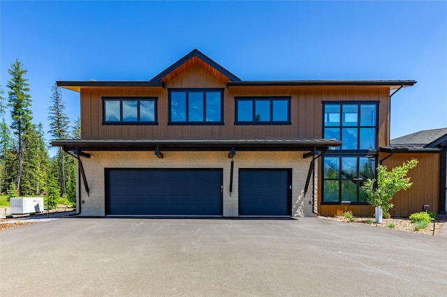 3900 Foothill Rd, Kalispell, MT 59901 - view of front facade featuring central AC unit, an attached garage, driveway, and brick siding