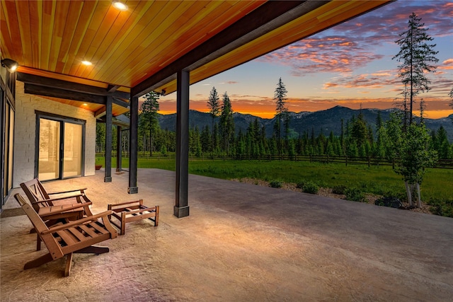 3900 Foothill Rd, Kalispell, MT 59901 - patio terrace at dusk with a mountain view and a patio