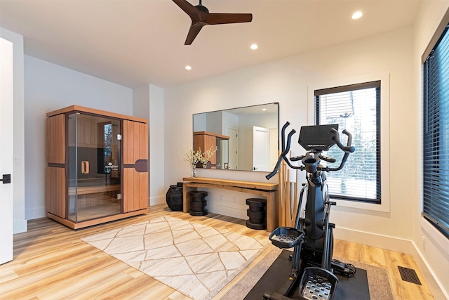 exercise area featuring ceiling fan and light wood-type flooring