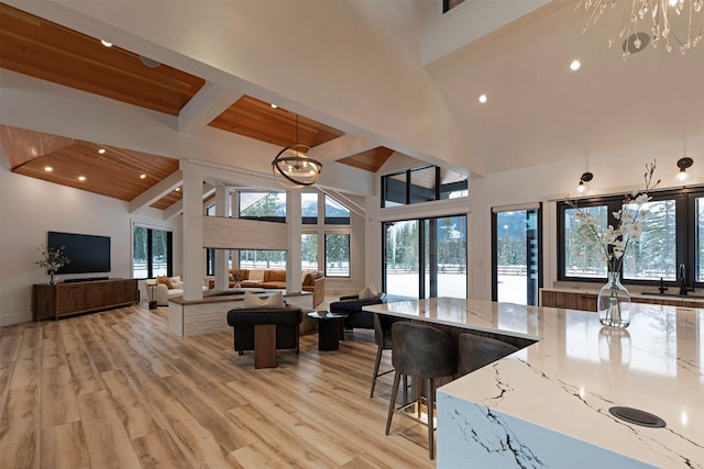 3900 Foothill Rd, Kalispell, MT 59901 - living room featuring high vaulted ceiling, beamed ceiling, light wood-style floors, and recessed lighting
