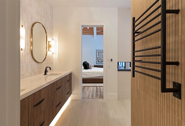 3900 Foothill Rd, Kalispell, MT 59901 - ensuite bathroom featuring wood finished floors, double vanity, and backsplash