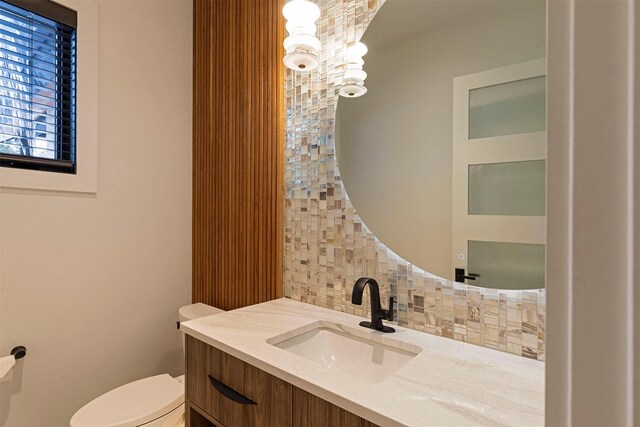3900 Foothill Rd, Kalispell, MT 59901 - bathroom with decorative backsplash, vanity, and toilet