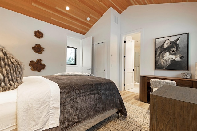 bedroom with vaulted ceiling, wood ceiling, and light hardwood / wood-style flooring