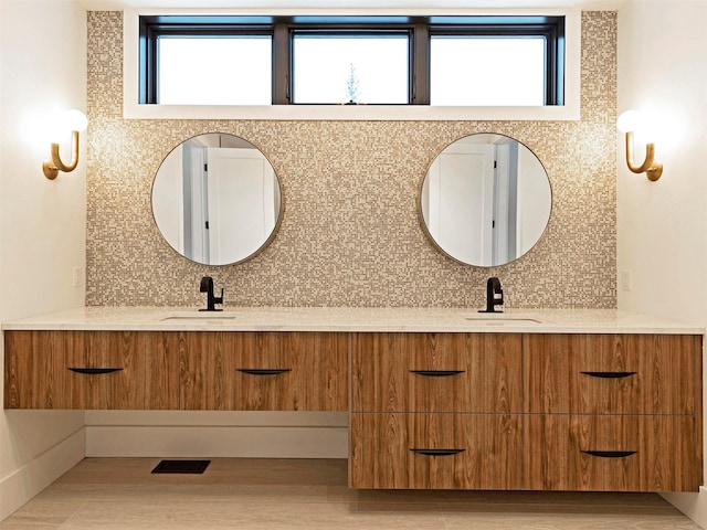 bathroom with vanity and decorative backsplash