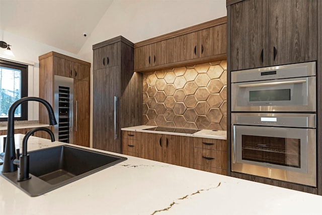 3900 Foothill Rd, Kalispell, MT 59901 - kitchen with black electric stovetop, beverage cooler, backsplash, a sink, and light countertops