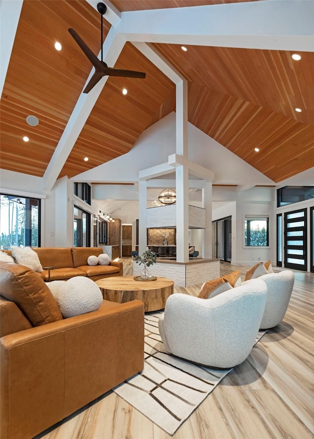 living room featuring ceiling fan, light hardwood / wood-style floors, high vaulted ceiling, and wooden ceiling