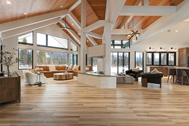 3900 Foothill Rd, Kalispell, MT 59901 - living area with high vaulted ceiling, recessed lighting, light wood finished floors, plenty of natural light, and wooden ceiling with exposed beams