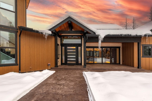 view of snow covered property entrance