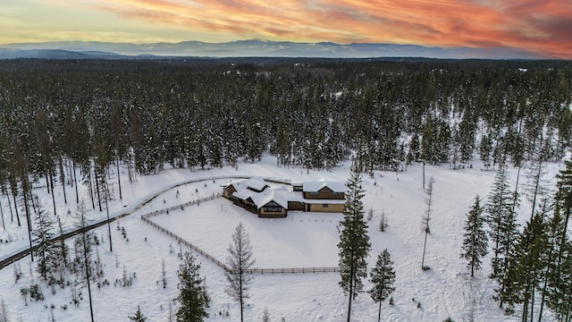 snowy aerial view with a mountain view