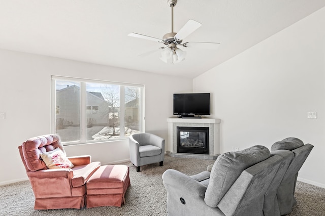 living room with lofted ceiling, a fireplace, ceiling fan, and carpet flooring