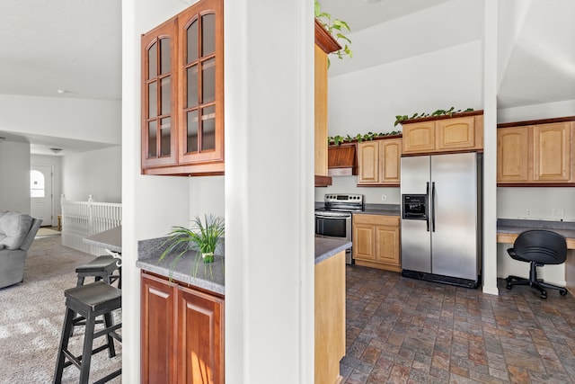 kitchen with stainless steel appliances and built in desk