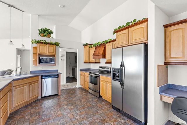 kitchen with lofted ceiling, sink, premium range hood, hanging light fixtures, and stainless steel appliances