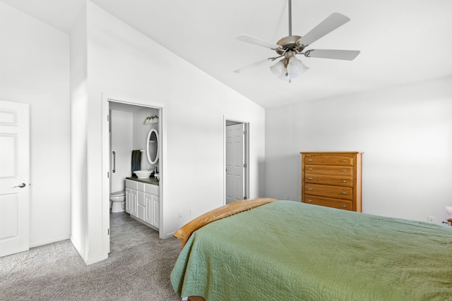 bedroom with ceiling fan, ensuite bath, vaulted ceiling, and carpet