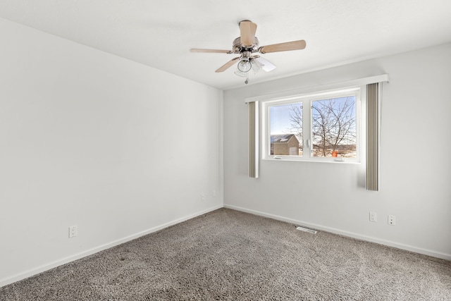 spare room featuring carpet floors and ceiling fan