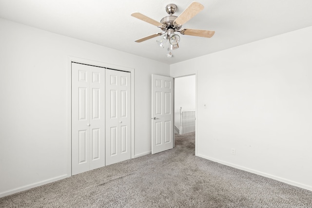 unfurnished bedroom featuring a closet, ceiling fan, and carpet flooring