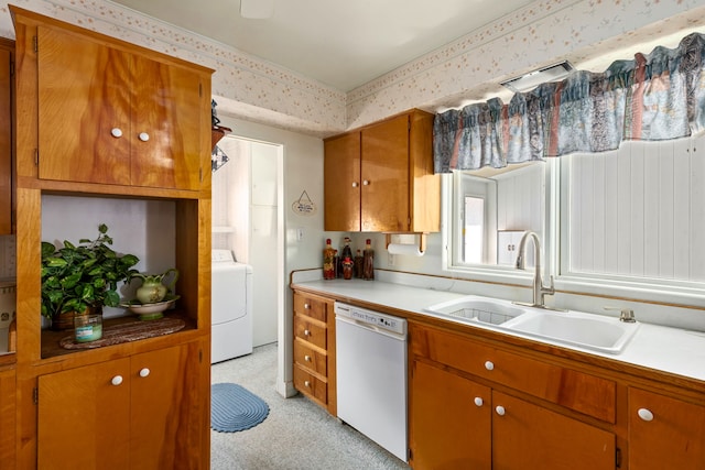 kitchen with light carpet, sink, washer / dryer, and dishwasher