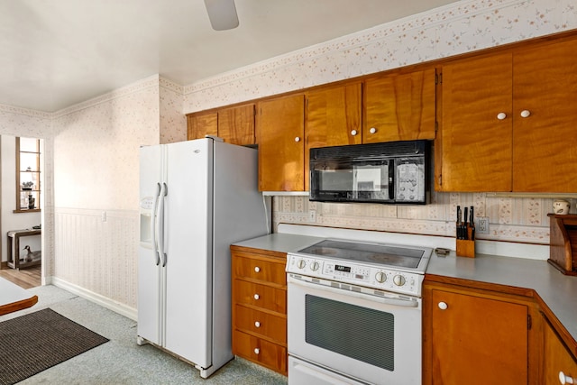 kitchen featuring white appliances and ceiling fan