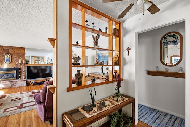 hall featuring hardwood / wood-style floors and a textured ceiling