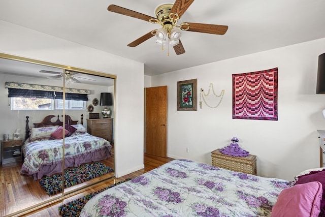 bedroom featuring hardwood / wood-style flooring, ceiling fan, and a closet