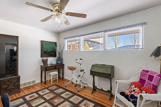 sitting room featuring hardwood / wood-style flooring and ceiling fan