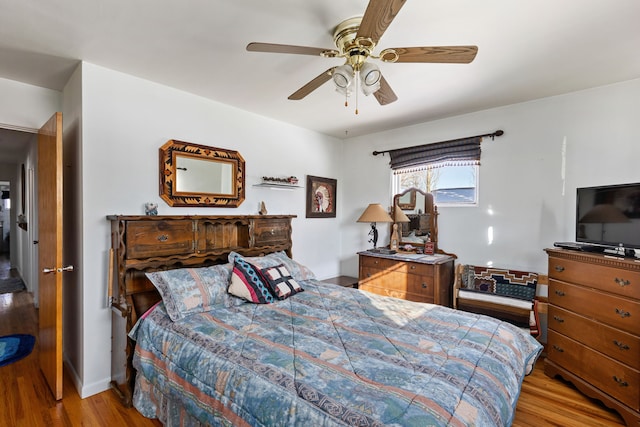 bedroom with ceiling fan and light hardwood / wood-style flooring