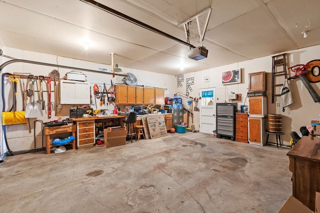 garage featuring a garage door opener and a workshop area